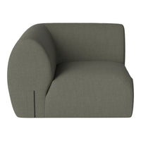"Modern green fabric sofa with a curved design, featuring a smooth, textured pattern."