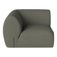 Curved, modern sofa in a soft olive green fabric with a smooth, textured surface and minimalist design.