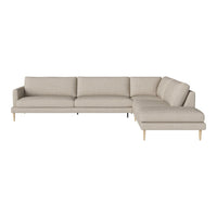 Light beige sectional sofa with clean lines and a minimalist design, featuring a soft, textured fabric and natural wood legs.