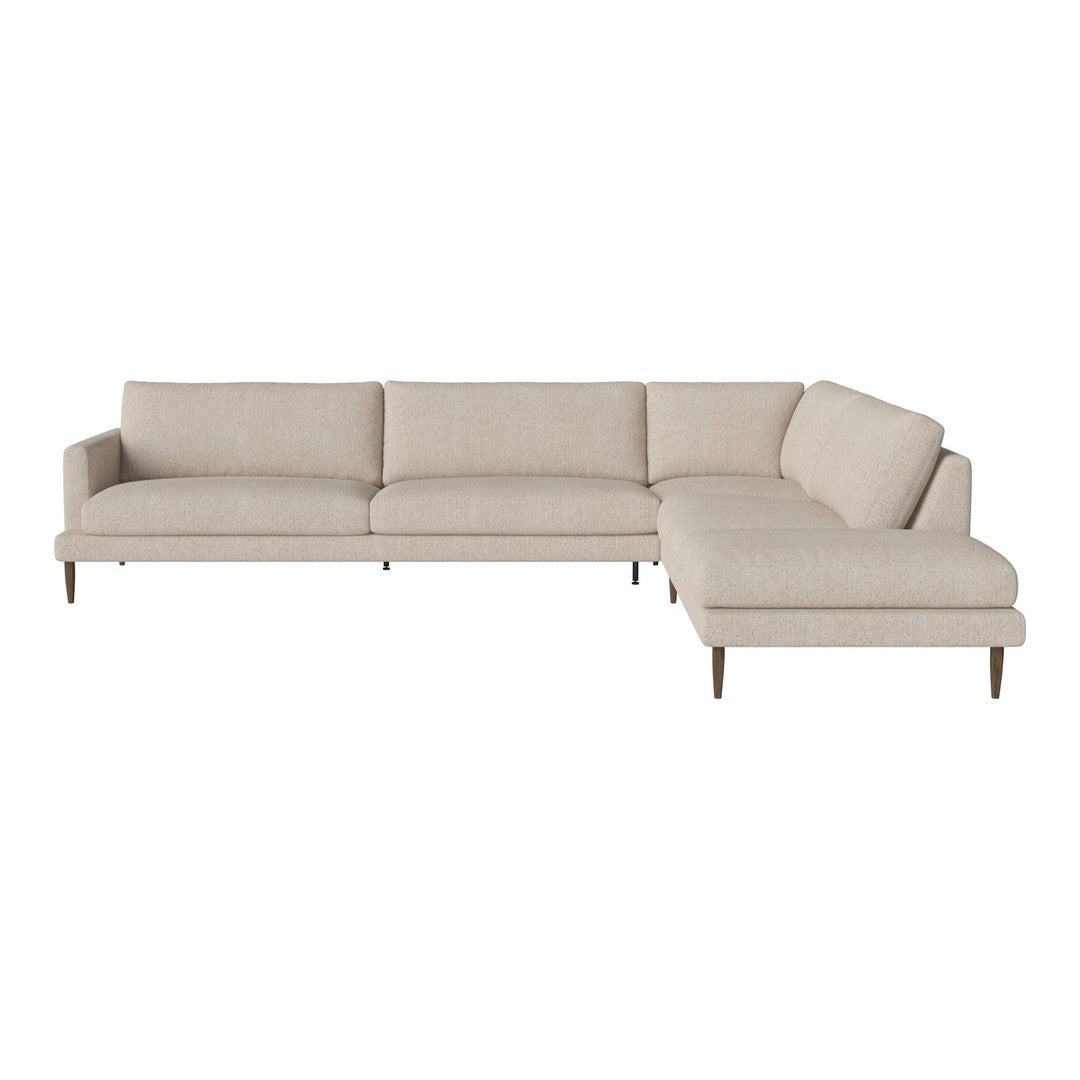 Light beige sectional sofa with smooth upholstery and minimalist design, featuring tapered wooden legs.