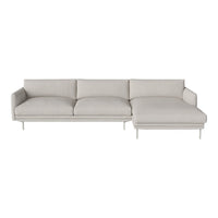Modern light gray sectional sofa with plush cushions and sleek metal legs, featuring a minimalistic design and smooth texture.