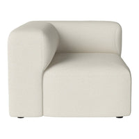 Cream-colored, minimalist corner chair with a textured fabric finish and clean, modern lines. Ideal for contemporary decor.