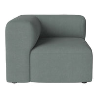 Soft gray upholstered corner chair with a modern, minimalist design and clean lines. 