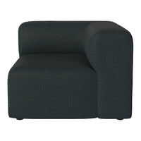Dark green upholstered corner sofa with a modern, textured pattern. Soft lines and minimalist design.