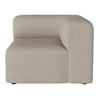 Beige upholstered corner sofa with a minimalist design and smooth, uniform fabric pattern.
