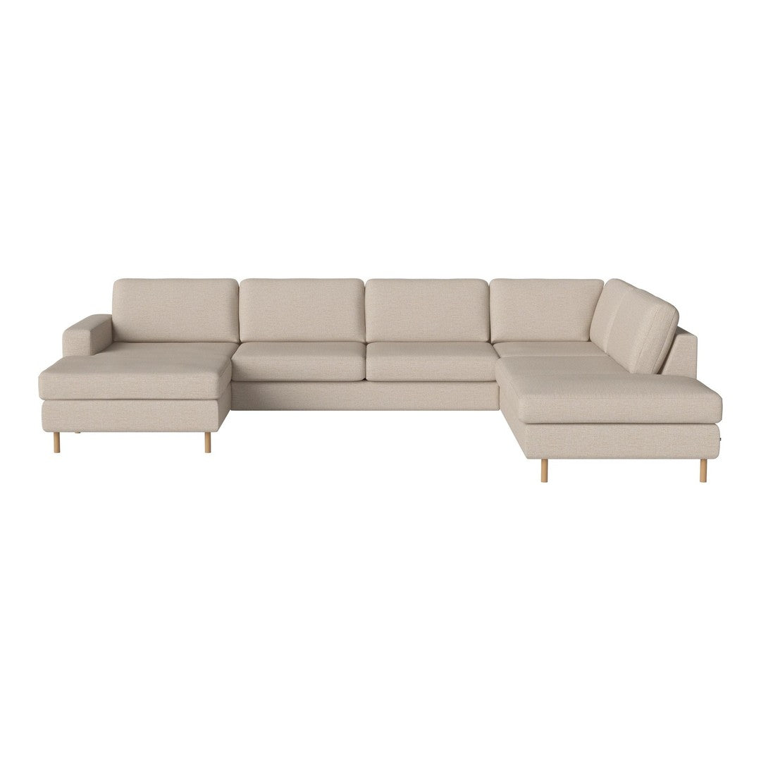 Beige sectional sofa with a modern design, featuring clean lines and subtle textures, complemented by light wooden legs.