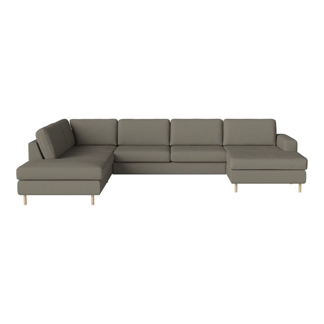 Modern sectional sofa in muted grey fabric with simple, clean lines and light wooden legs.