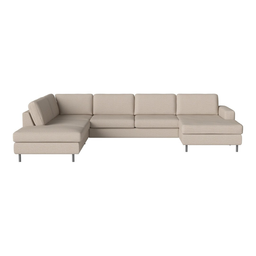 Beige sectional sofa with a modern, minimalist design featuring clean lines and a soft, textured fabric.