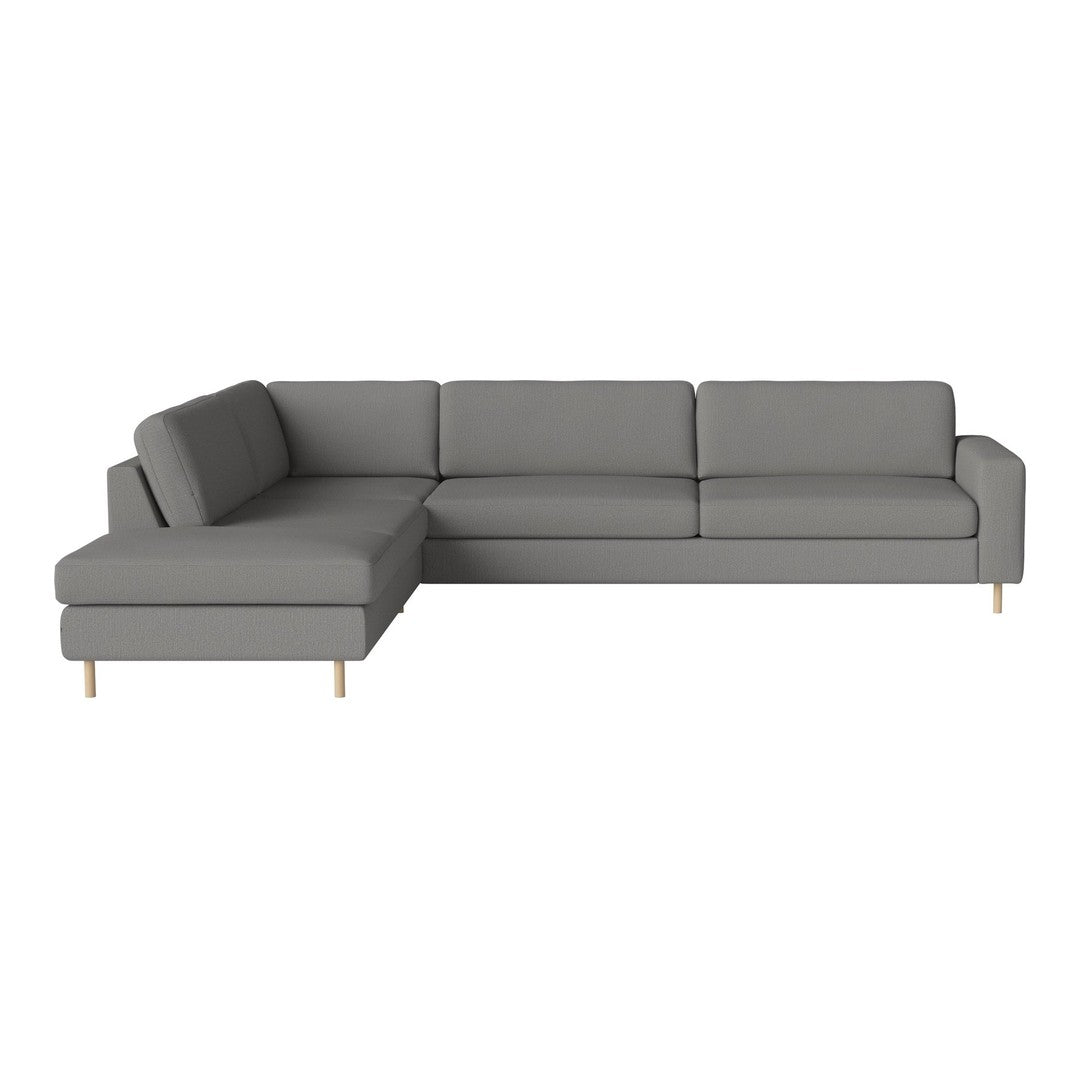 Grey sectional sofa with a modern design and smooth fabric texture, featuring light wood legs.