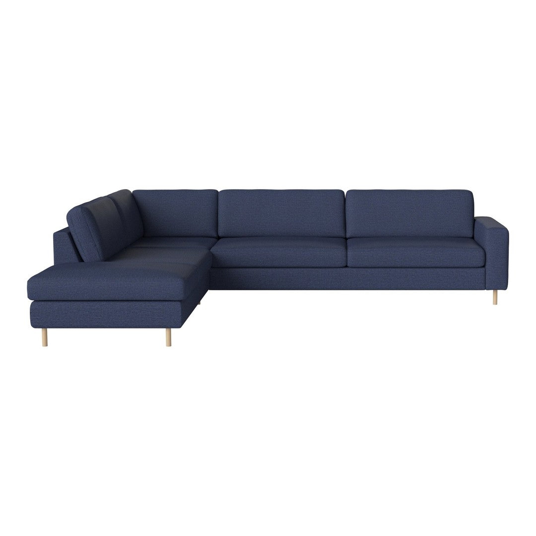 Navy blue sectional sofa with clean lines and subtle ribbed pattern, featuring light wooden legs for a modern touch.