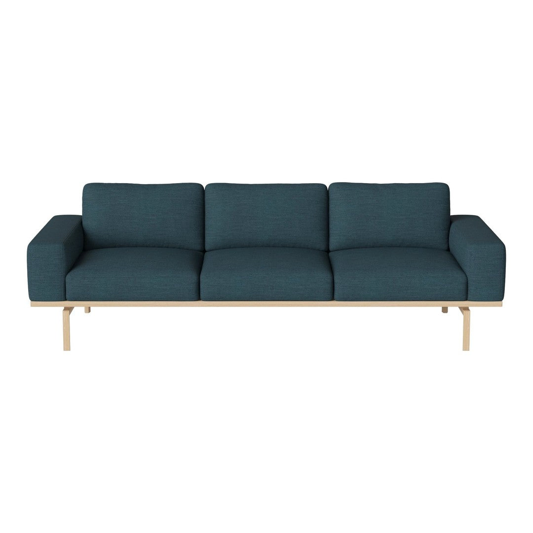 Teal fabric sofa with clean lines and a light wood frame, featuring a minimalist design and no visible patterns.
