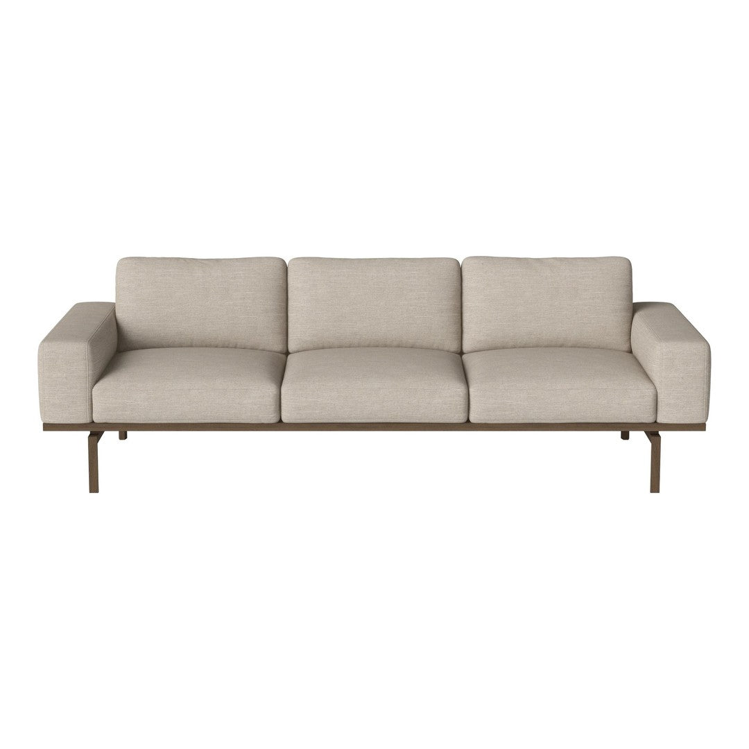 Modern beige sofa with clean lines and a minimalist design, featuring smooth upholstery and a sleek metal frame.