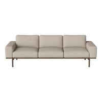 Modern beige sofa with clean lines and a minimalist design, featuring smooth upholstery and a sleek metal frame.