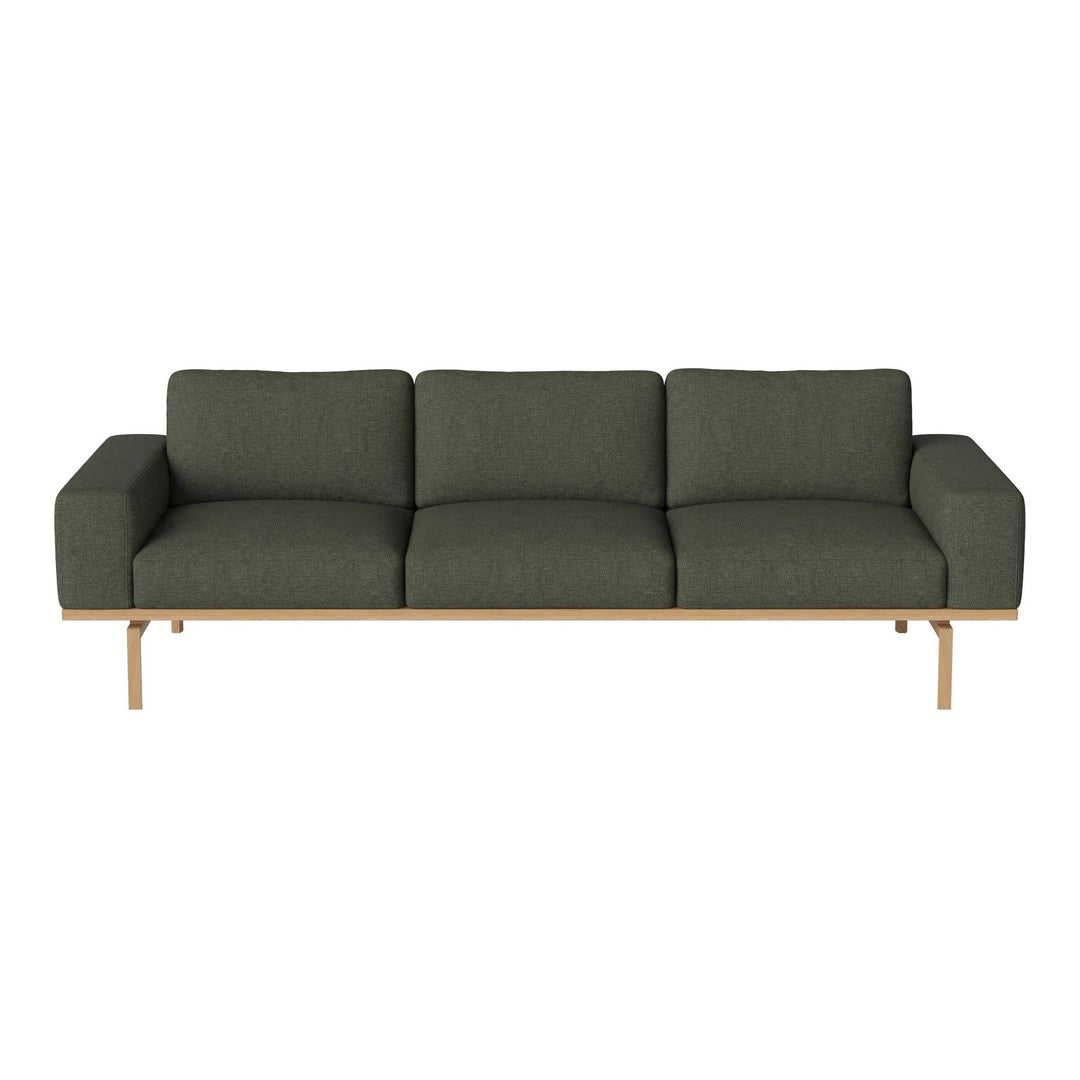 Sleek green fabric sofa with a modern design and natural wood legs, perfect for contemporary living spaces.