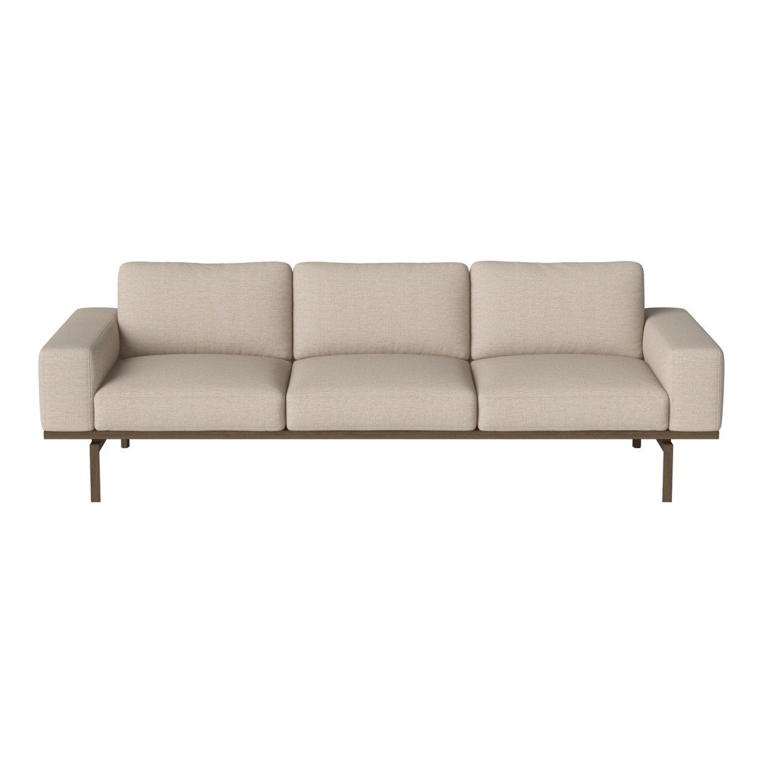 Light beige fabric sofa with a minimalist design and subtle texture, complemented by a sleek metal frame.