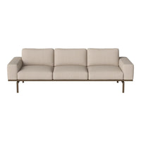Light beige fabric sofa with a minimalist design and subtle texture, complemented by a sleek metal frame.