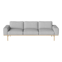 Light gray sofa with a minimalist design, featuring smooth fabric and a natural wood base. Perfect for modern decor.