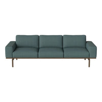 Teal upholstered sofa with a geometric pattern and sleek wooden frame, adding a modern touch to any living space.