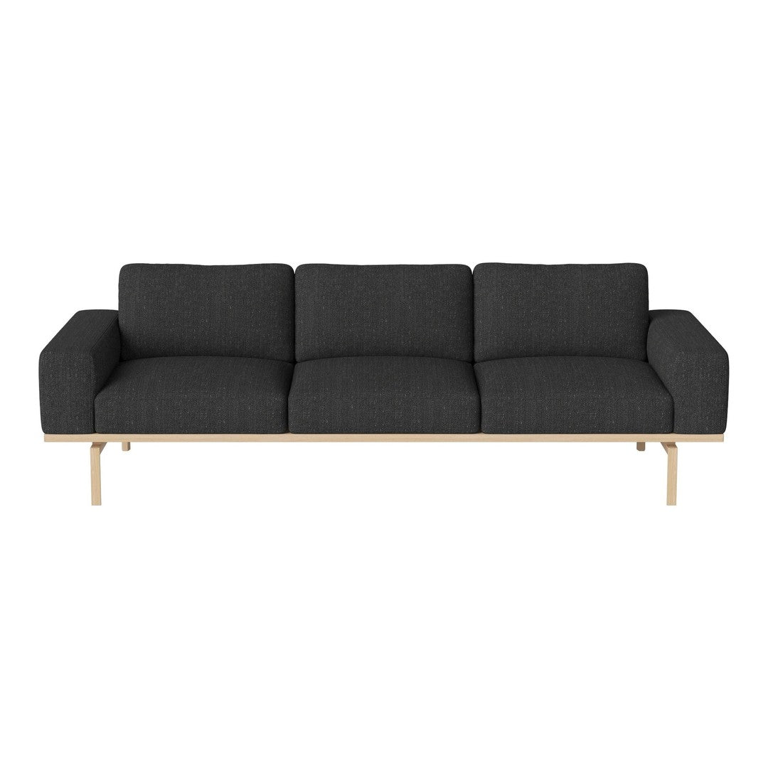 Sleek dark gray sofa with a minimalist design and light wood legs for a modern, stylish touch.