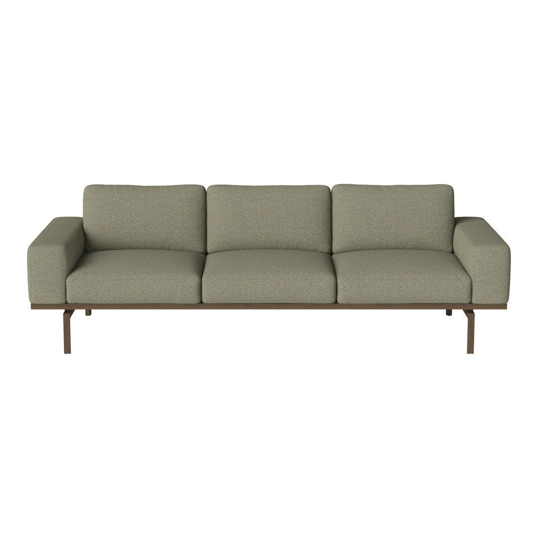 Sleek green sofa with a textured fabric and minimalist metal base, perfect for modern living spaces.
