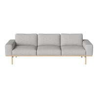 Light gray modern sofa with clean lines and soft fabric upholstery, accented by a natural wood base.