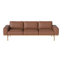 Brown leather sofa with a sleek design and light wooden frame, featuring smooth, minimalist lines.