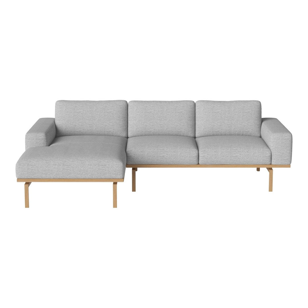 Light gray fabric sectional sofa with smooth lines and wooden legs, featuring a minimalist design.