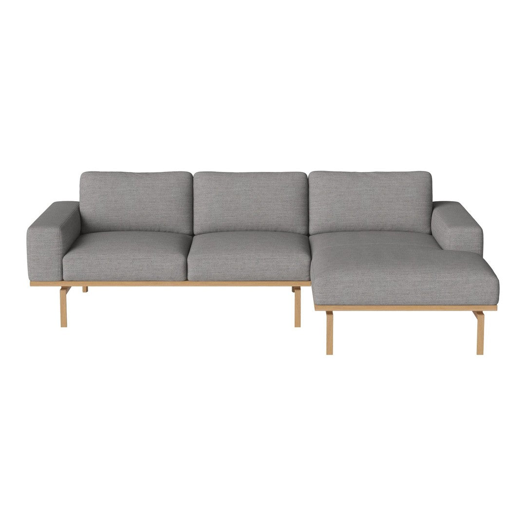 Gray upholstered sectional sofa with clean lines and natural wood legs, featuring a minimalist modern design.