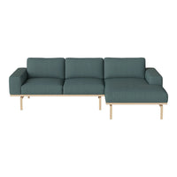 Teal fabric sectional sofa with a simple textured pattern and light wood legs. Perfect blend of comfort and modern style.