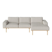 Light gray sofa with a minimalist design and wooden legs, featuring smooth upholstery and a contemporary layout.