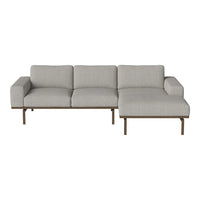 Modern grey sectional sofa with a minimalist design and textured fabric, featuring sturdy metal legs.