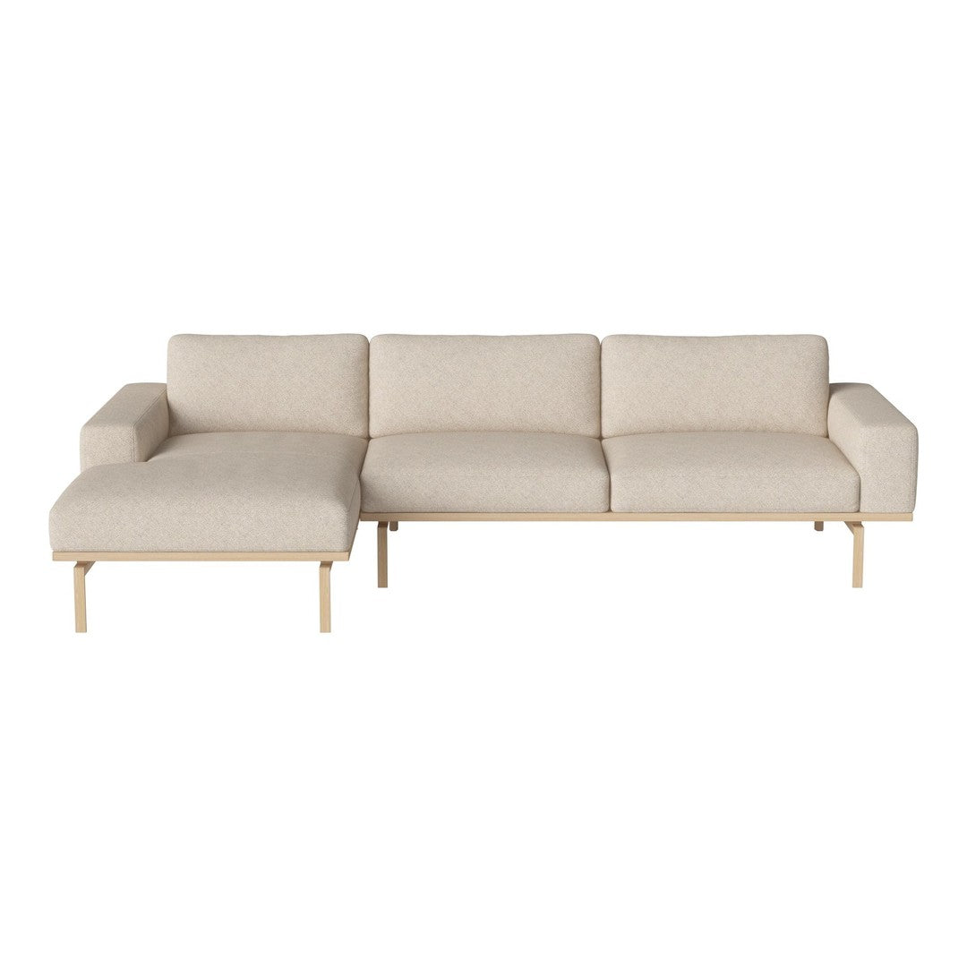 Beige sectional sofa with a minimalist design and subtle textured fabric, featuring light wooden legs.