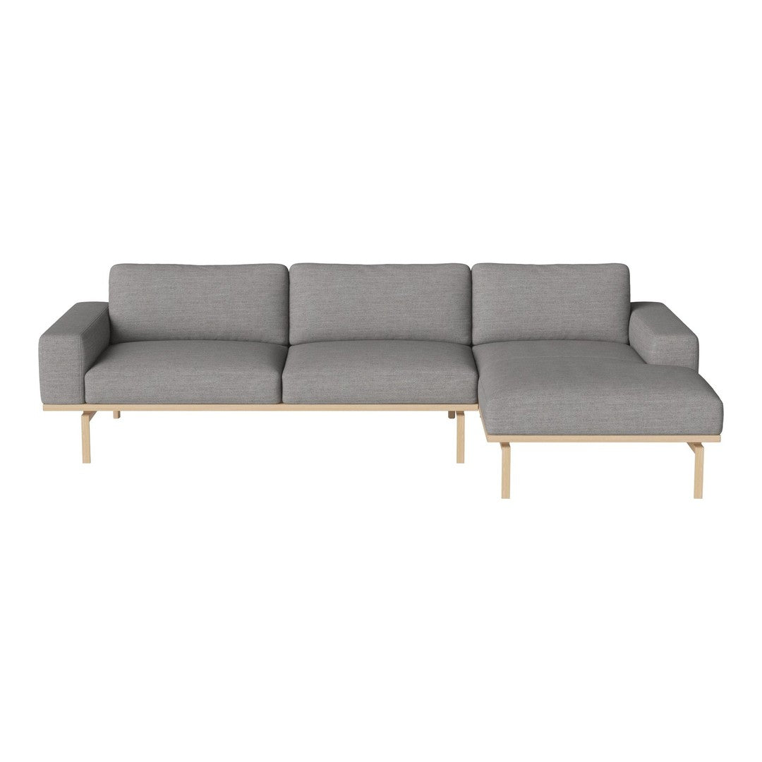 Modern gray sectional sofa with a minimalist design and natural wood legs, perfect for contemporary living spaces.