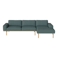 Teal sofa with a modern design, featuring a clean pattern and light wooden legs for a stylish touch.