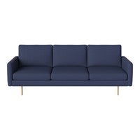 Navy blue modern sofa with clean lines and minimalistic design, featuring solid light wood legs.