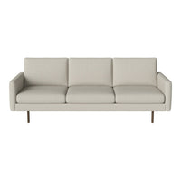 Light beige upholstered sofa with a minimalist design and smooth, solid-colored cushions.