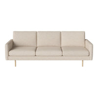 Beige three-seat sofa with minimalist design and subtle textured upholstery, complemented by light wood legs.