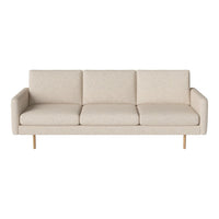 Light beige sofa with subtle texture, featuring a minimalist design and wooden legs for a modern look.