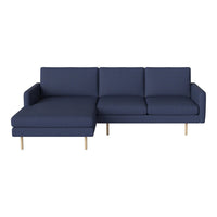 Navy blue sectional sofa with a modern design and smooth fabric, featuring minimalist wooden legs.