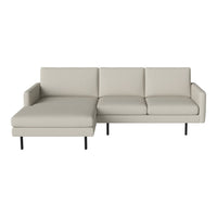 "Light gray modern sectional sofa with sleek lines and subtle tufting on a minimalist black leg frame."
