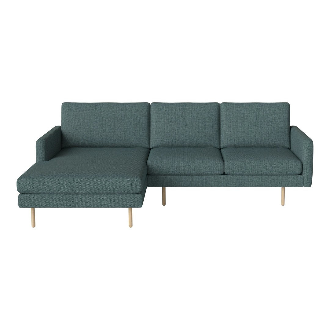 Teal sectional sofa with simple, clean lines and light wood legs, featuring a solid color upholstery.