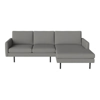 Gray sectional sofa with clean lines and a minimalist design, featuring smooth fabric and sleek black legs.
