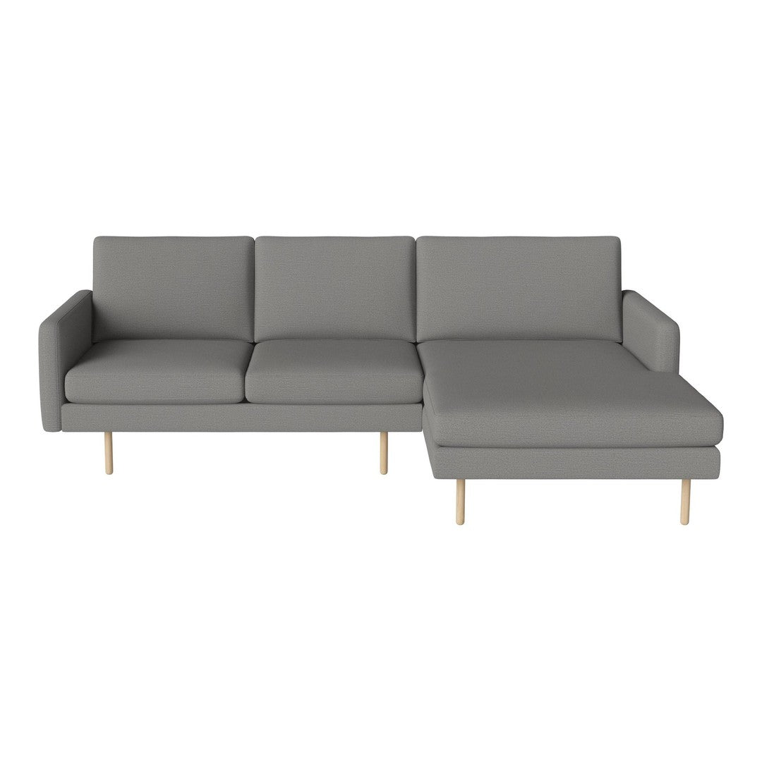 Grey sectional sofa with modern design, featuring clean lines and wooden legs. Ideal for contemporary living spaces.