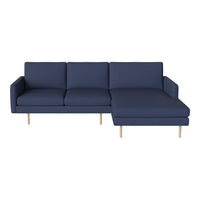 Navy blue sectional sofa with clean lines and light wooden legs, ideal for modern living spaces.