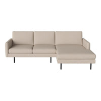 Beige sectional sofa with clean lines and minimalist design, featuring a smooth fabric texture and black metal legs.