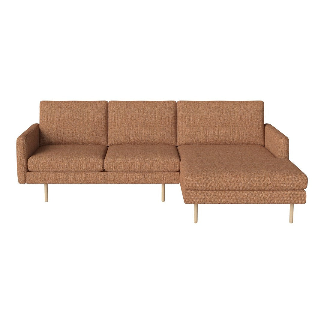 Rust-colored sectional sofa with a minimalist design and textured fabric upholstery, featuring a sleek wood leg finish.