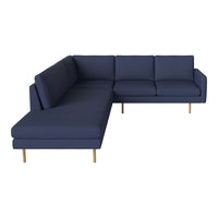 Navy blue sectional sofa with solid fabric and clean lines, featuring light wood legs. Ideal for modern spaces.