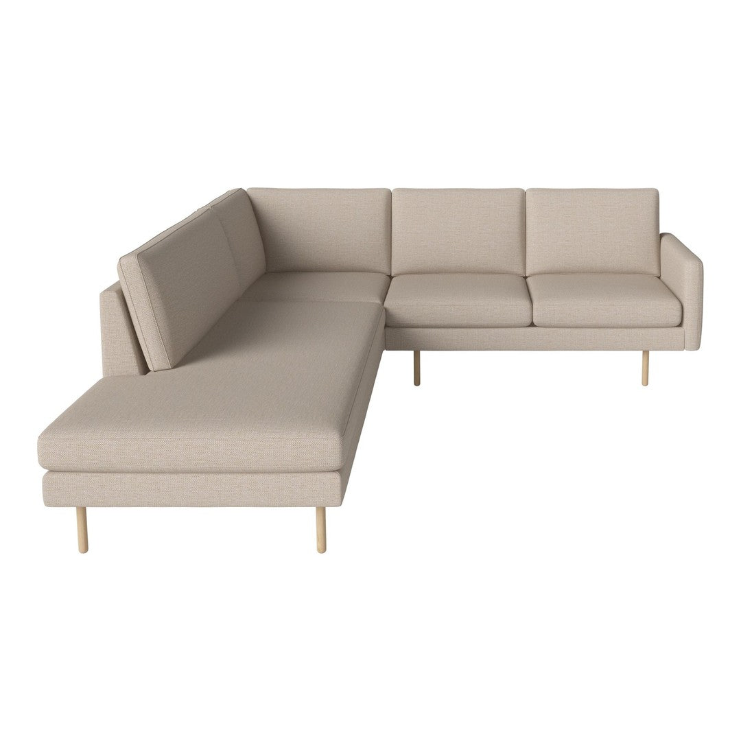 Beige sectional sofa with clean lines and minimalist design, featuring smooth fabric and light wooden legs.