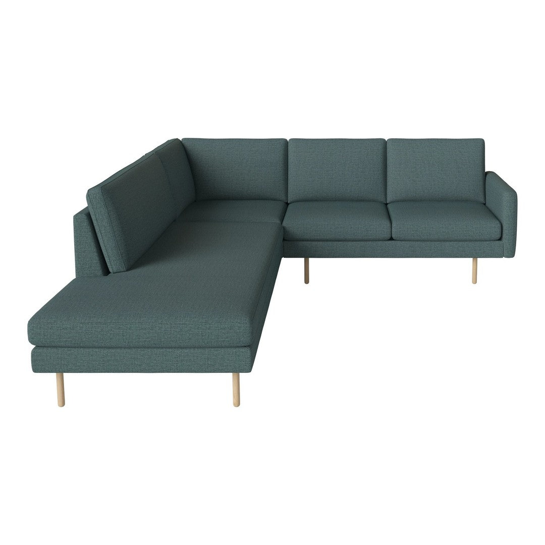 Teal sectional sofa with a textured fabric, featuring clean lines and light wooden legs. Ideal for modern decor.
