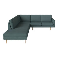 Teal sectional sofa with a textured fabric, featuring clean lines and light wooden legs. Ideal for modern decor.